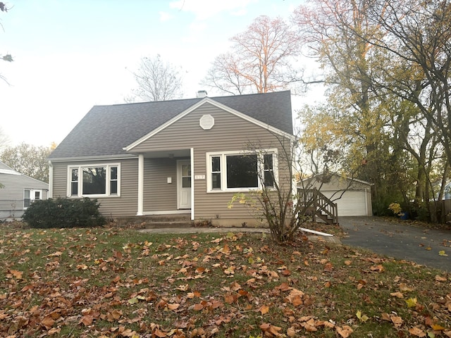 view of front of house featuring a garage and an outdoor structure