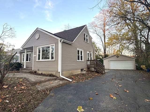 view of side of home with a garage and an outbuilding