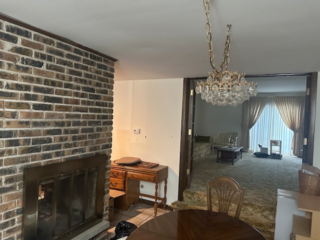 carpeted dining area with an inviting chandelier and a brick fireplace