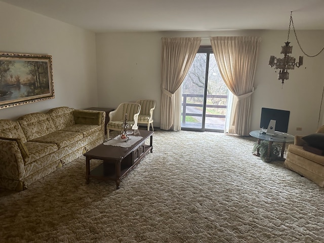 living room featuring a chandelier and carpet