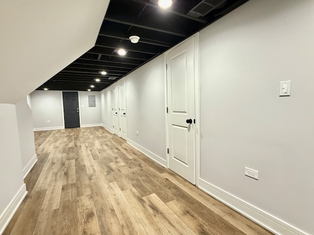 corridor with light hardwood / wood-style flooring