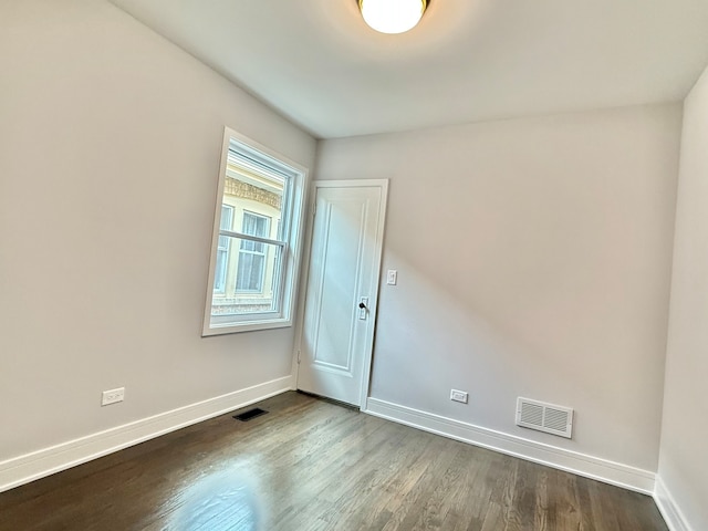 spare room with hardwood / wood-style flooring