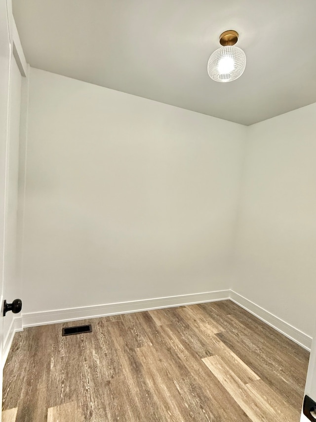 spare room with hardwood / wood-style floors