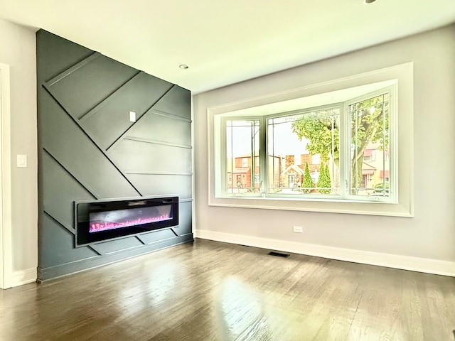 unfurnished room with hardwood / wood-style flooring