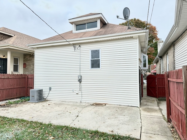 rear view of property with a patio and central air condition unit