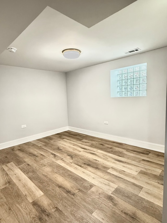 spare room with wood-type flooring