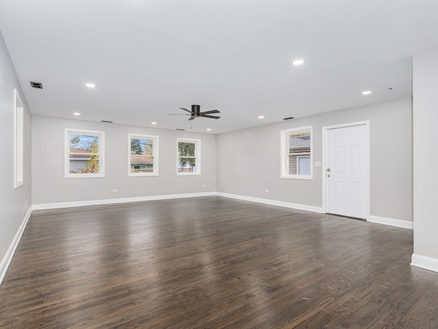 unfurnished living room with ceiling fan and dark hardwood / wood-style flooring