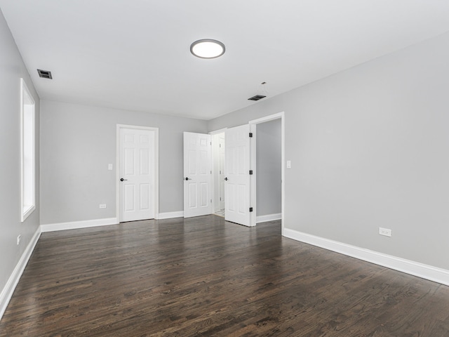 unfurnished bedroom featuring dark hardwood / wood-style floors