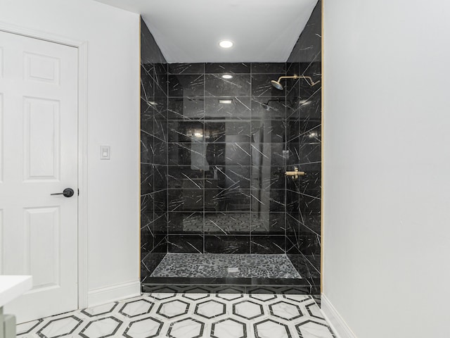 bathroom featuring tile patterned flooring and a tile shower