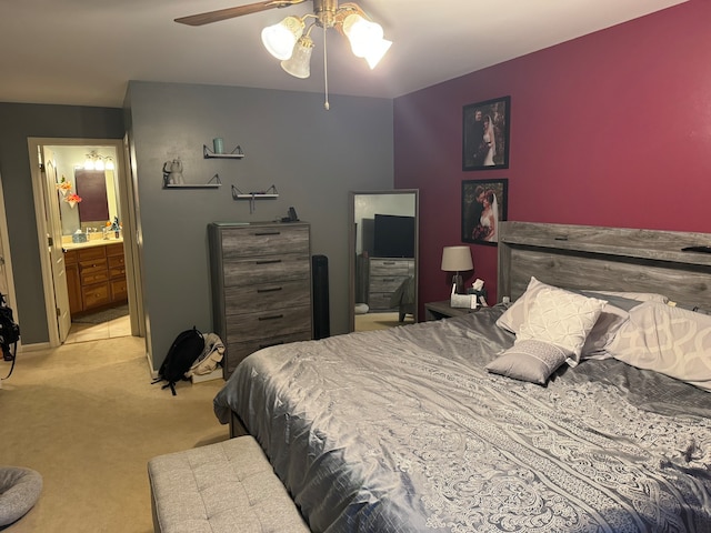 carpeted bedroom with ceiling fan, sink, and connected bathroom