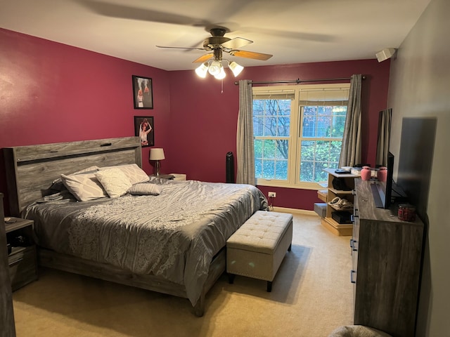 bedroom featuring light carpet and ceiling fan