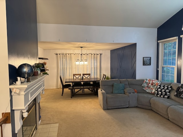 carpeted living room featuring lofted ceiling, a wealth of natural light, and a notable chandelier