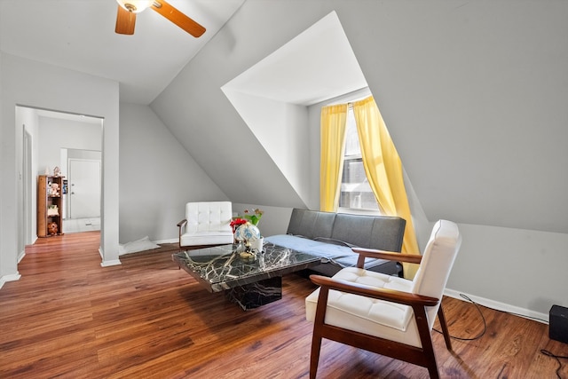 living area with lofted ceiling, hardwood / wood-style flooring, and ceiling fan