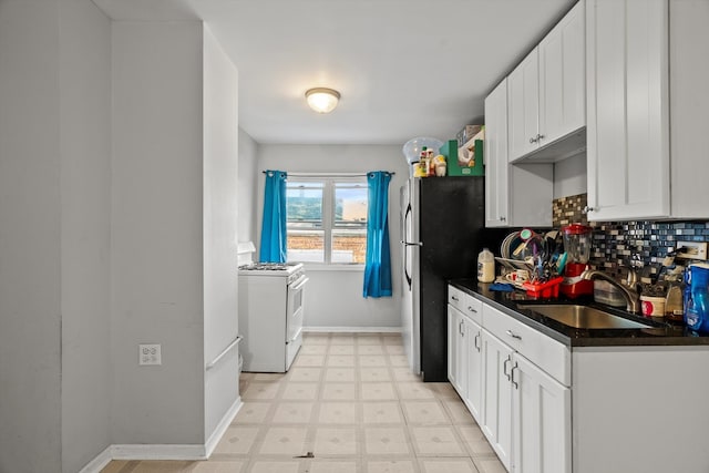 kitchen with white cabinetry, sink, white range with gas cooktop, and tasteful backsplash