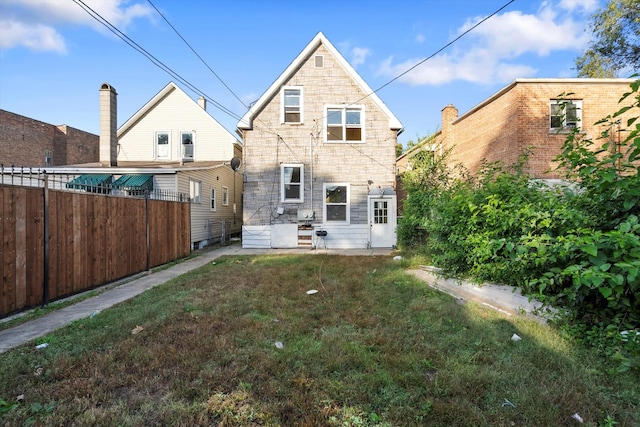 rear view of house with a yard