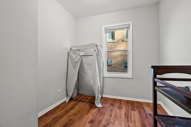 bedroom with dark wood-type flooring