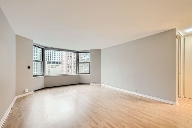 unfurnished room with light hardwood / wood-style flooring