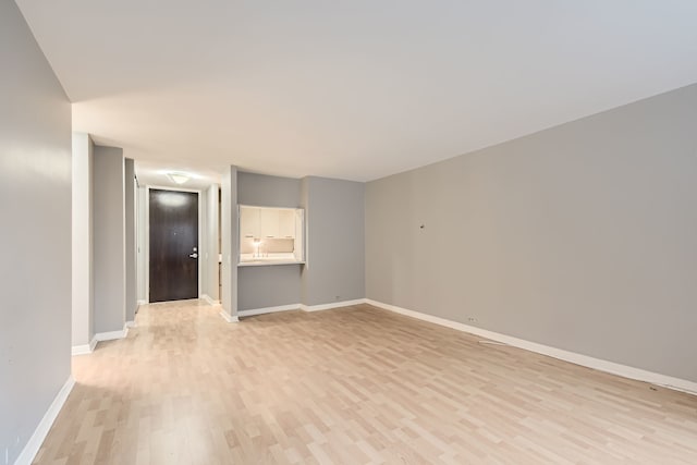 unfurnished room with light hardwood / wood-style floors