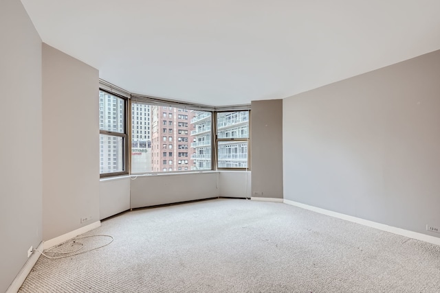 unfurnished room with light colored carpet