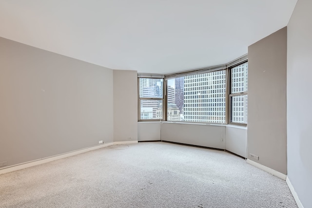 unfurnished room with plenty of natural light and light colored carpet