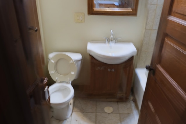 bathroom featuring vanity, tile patterned floors, and toilet