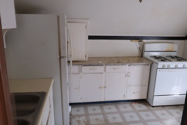 kitchen featuring white appliances and white cabinetry