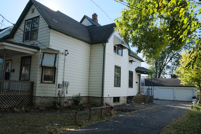 view of side of property with a garage and an outbuilding