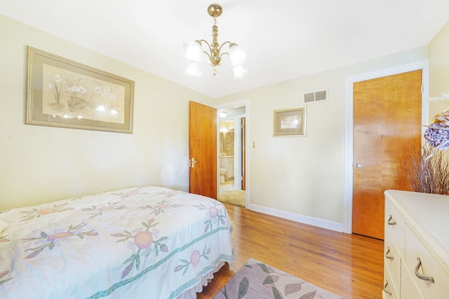 bedroom with a chandelier and hardwood / wood-style floors