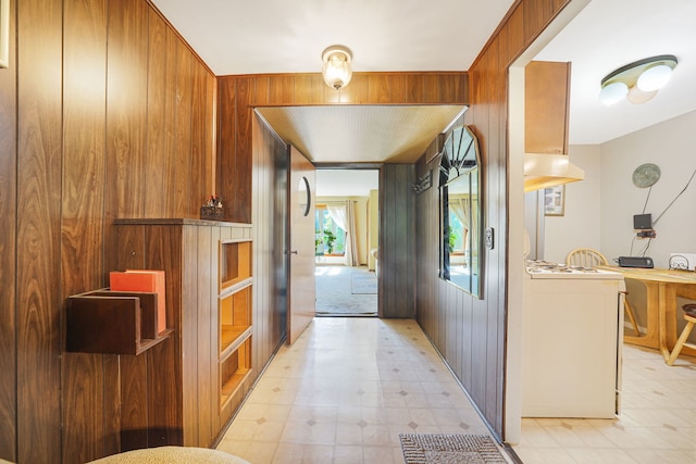 kitchen with lofted ceiling, wooden walls, and white fridge