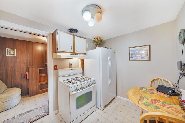 kitchen featuring hanging light fixtures, white cabinetry, sink, and backsplash