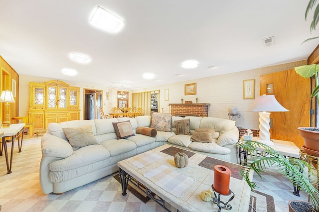 living room with a fireplace, wood walls, and plenty of natural light