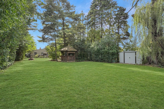 view of yard with a storage shed and a gazebo