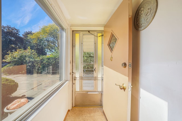 doorway to outside featuring light tile patterned flooring