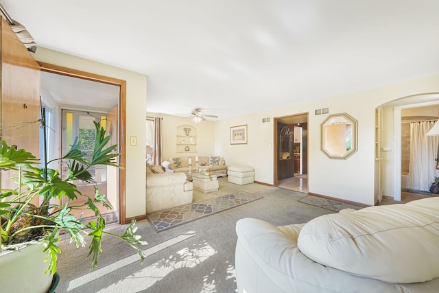 living room with light carpet and ceiling fan