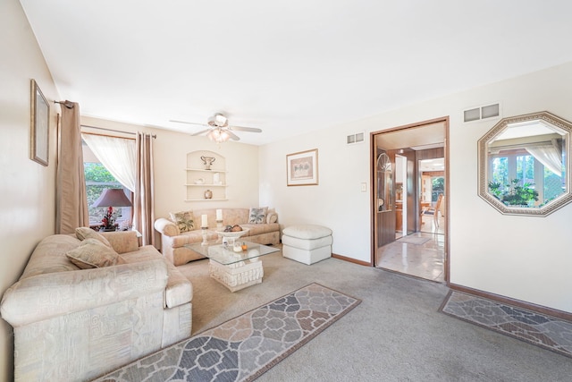 living room with light carpet and ceiling fan