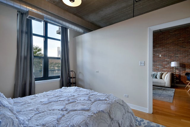 bedroom with hardwood / wood-style floors