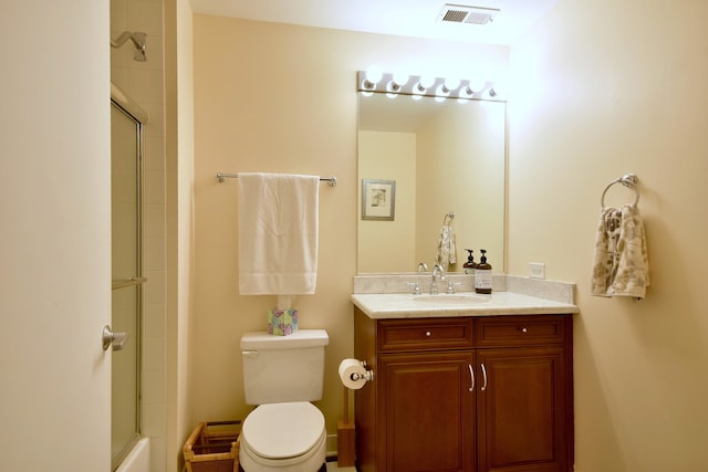 full bathroom with toilet, combined bath / shower with glass door, and vanity