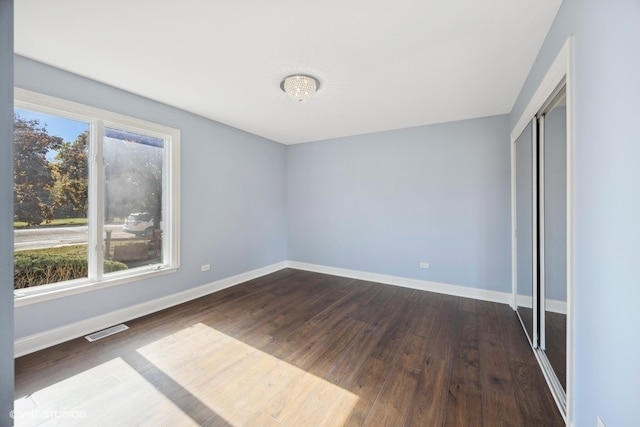 unfurnished bedroom with wood-type flooring and a closet