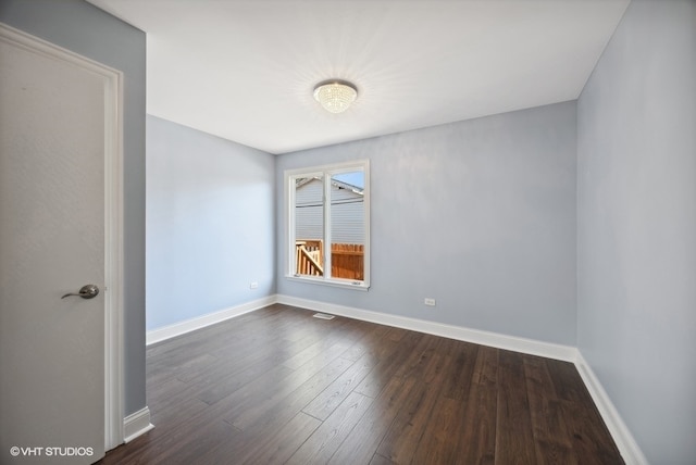 spare room with dark wood-type flooring