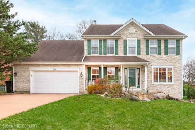 colonial house with a garage and a front lawn