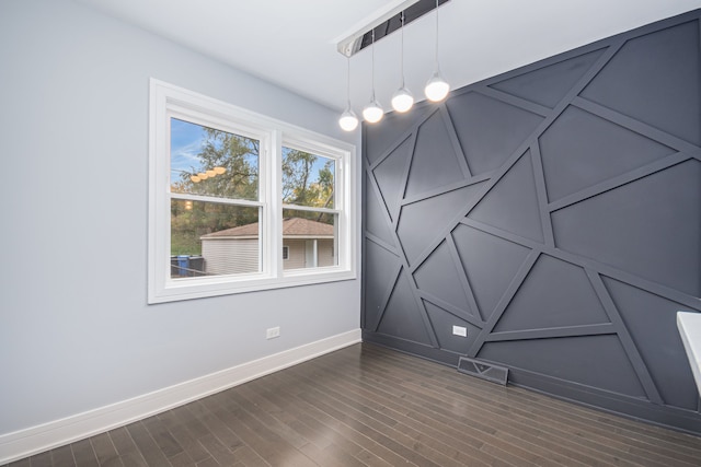 empty room featuring dark wood-type flooring