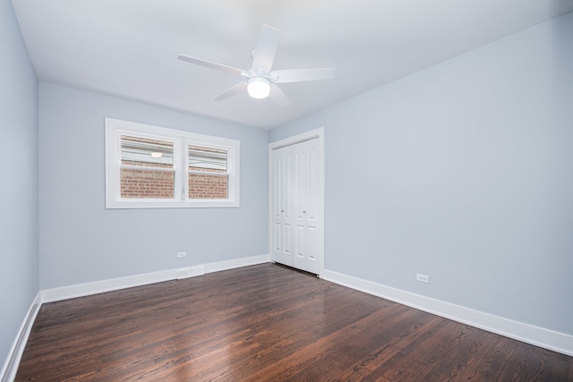 spare room featuring ceiling fan and dark hardwood / wood-style floors