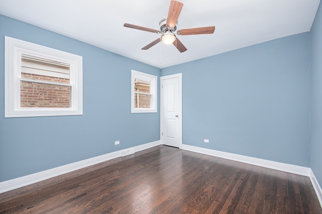 empty room featuring dark hardwood / wood-style flooring and ceiling fan