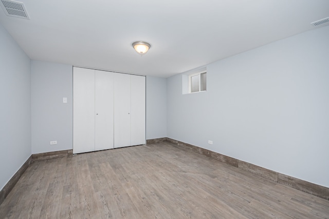 unfurnished bedroom with a closet and light hardwood / wood-style flooring