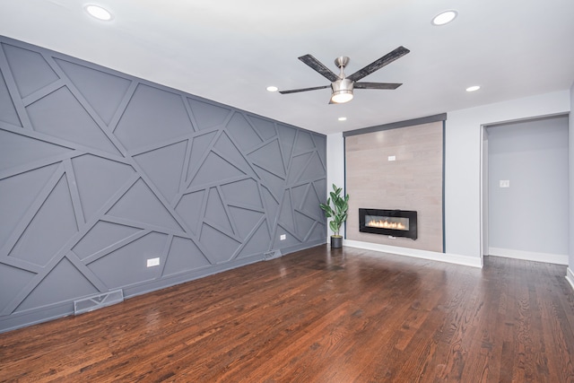 unfurnished living room featuring a fireplace, dark hardwood / wood-style floors, and ceiling fan