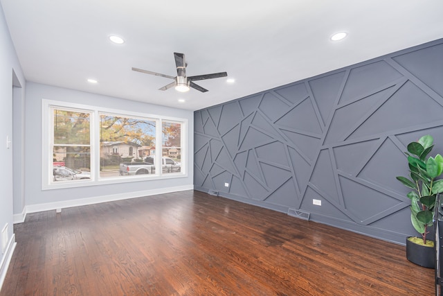 spare room with ceiling fan and dark hardwood / wood-style floors