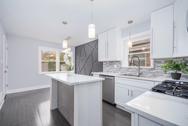 kitchen featuring white cabinetry, appliances with stainless steel finishes, dark hardwood / wood-style floors, and hanging light fixtures