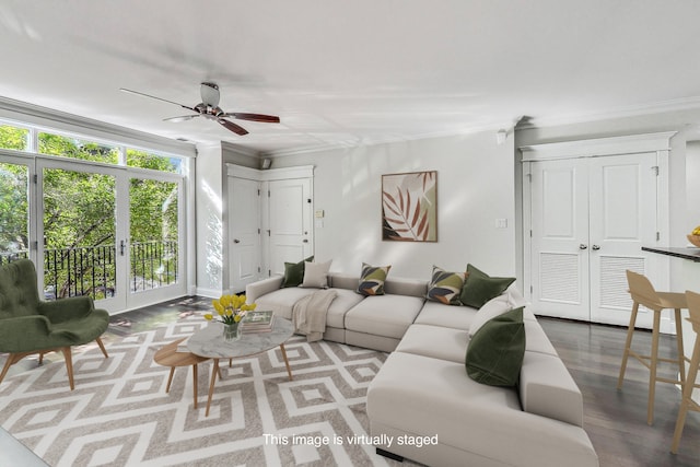 living room with wood-type flooring, ceiling fan, and crown molding