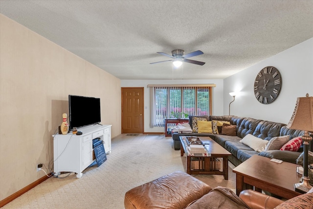 carpeted living room with a textured ceiling and ceiling fan