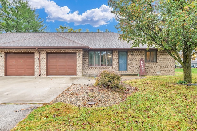 ranch-style house featuring a garage and a front yard